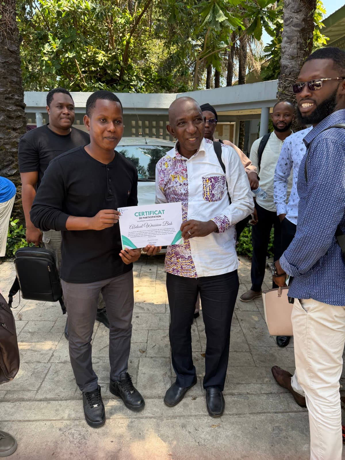 A certificate presentation to a June cohort participant.